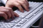 hands typing on keyboard